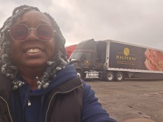 A construction worker writes notes on a clipboard at a construction site, emphasizing planning and precision.